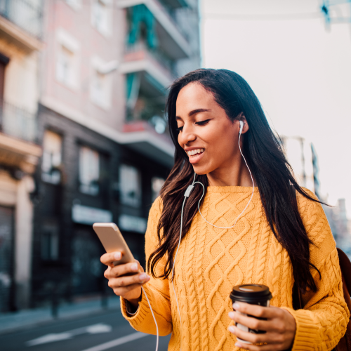 Woman Using Her Phone Wearing A yellow Jumper